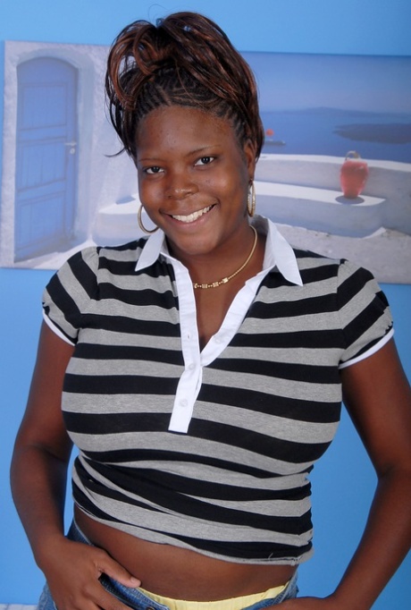 Older black woman Athena holds her large breasts while getting undressed 21700442
