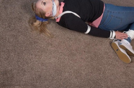 Fair skinned blonde sports a cleave gag while hogtied in her clothes 41821809