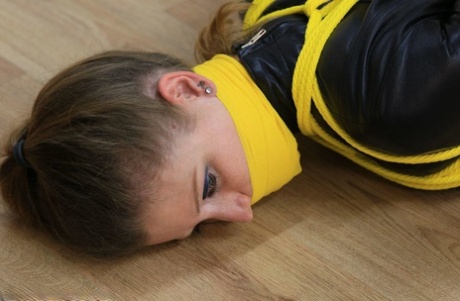 Caucasian girl is silenced while tied up with yellow rope in her clothing 80251229