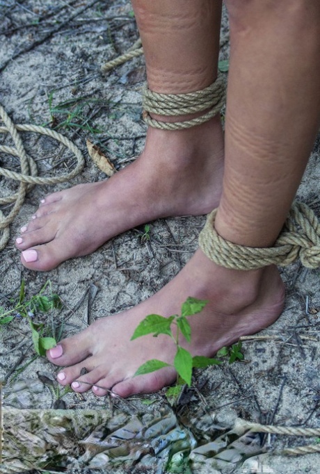 Skinny chick Jacinta B is tied up and suspended by rope in the woods 61656502