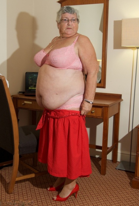 Obese granny Dirty Doctor gets naked in tan hosiery while watching XXX action 34288327