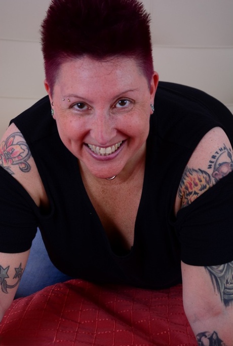 Overweight amateur Tattoo Girl lets a breast escape from her bra on a bed 54140105