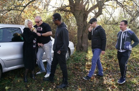 Mature blonde woman eats a banana before a gangbang in the countryside 38201349