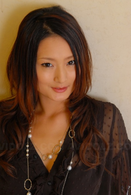 Beautiful Japanese female shows off her sleek legs in black shorts and heels 82006925