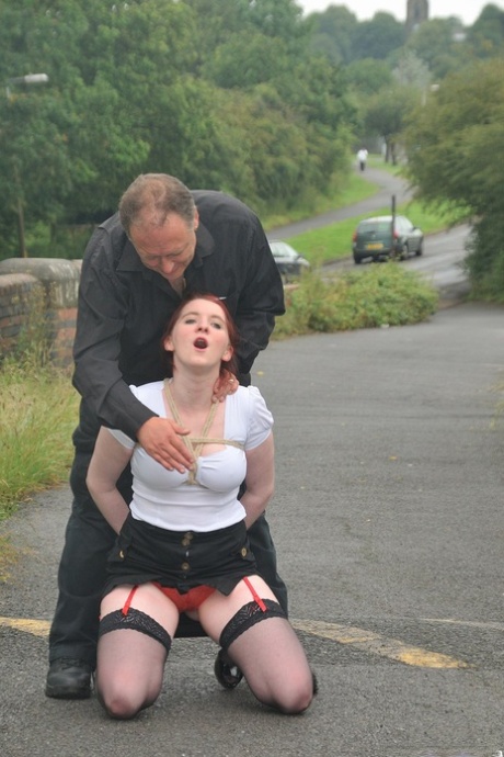 Redhead licks her Master's boots in parking lot before crawling on all fours 86813147