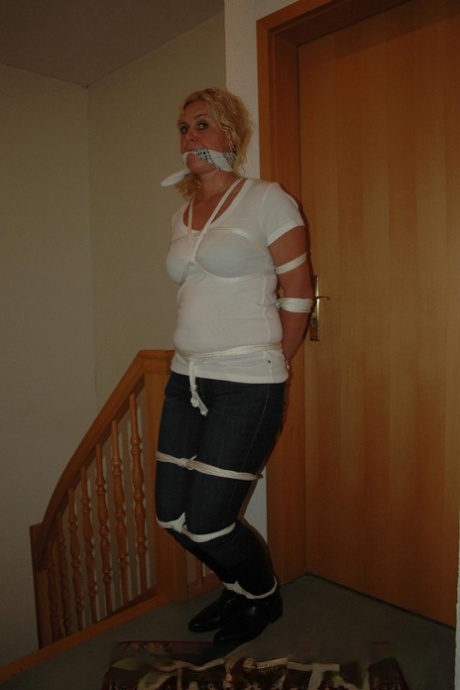 Fully clothed blonde struggles against a cleave gag while tied up with rope 68764609
