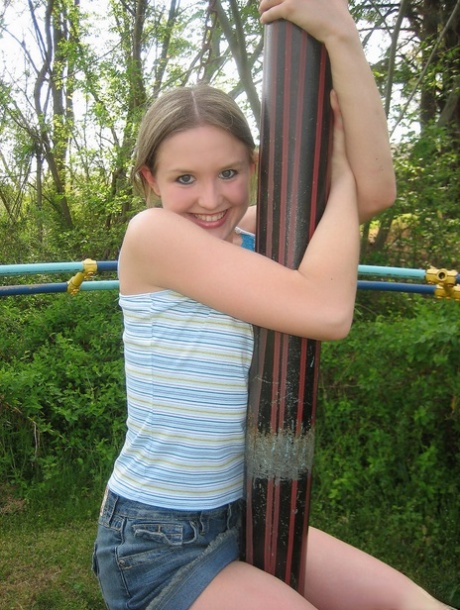 Young amateur exposes her small tits during upskirt action at a playground 32599521