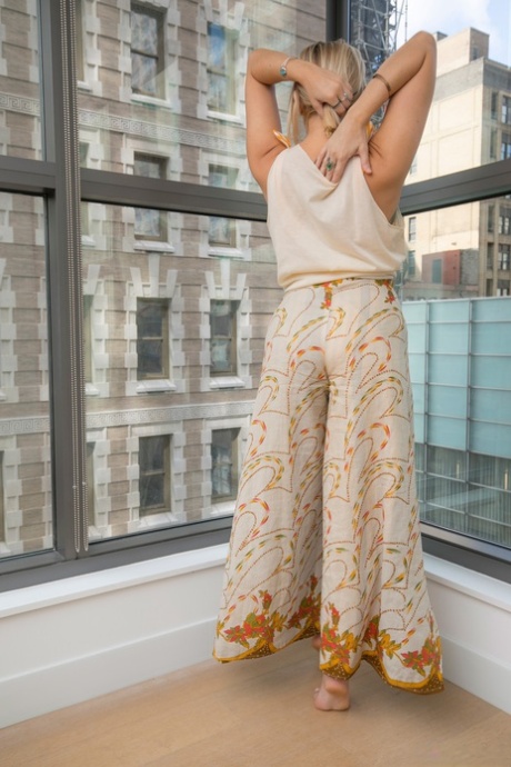 Blonde amateur Zena Johnson strips totally naked afore a condo window 94172937