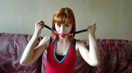 Kinky redhead affixes herself with a ball gag before tying herself up 75104484
