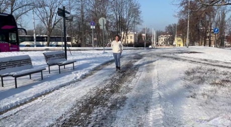 White girl Juliia takes a piss on a snow-covered path during the day 27323086