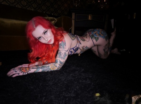 Tattooed redhead Loveless models a bra and thong ensemble in heels 80515803